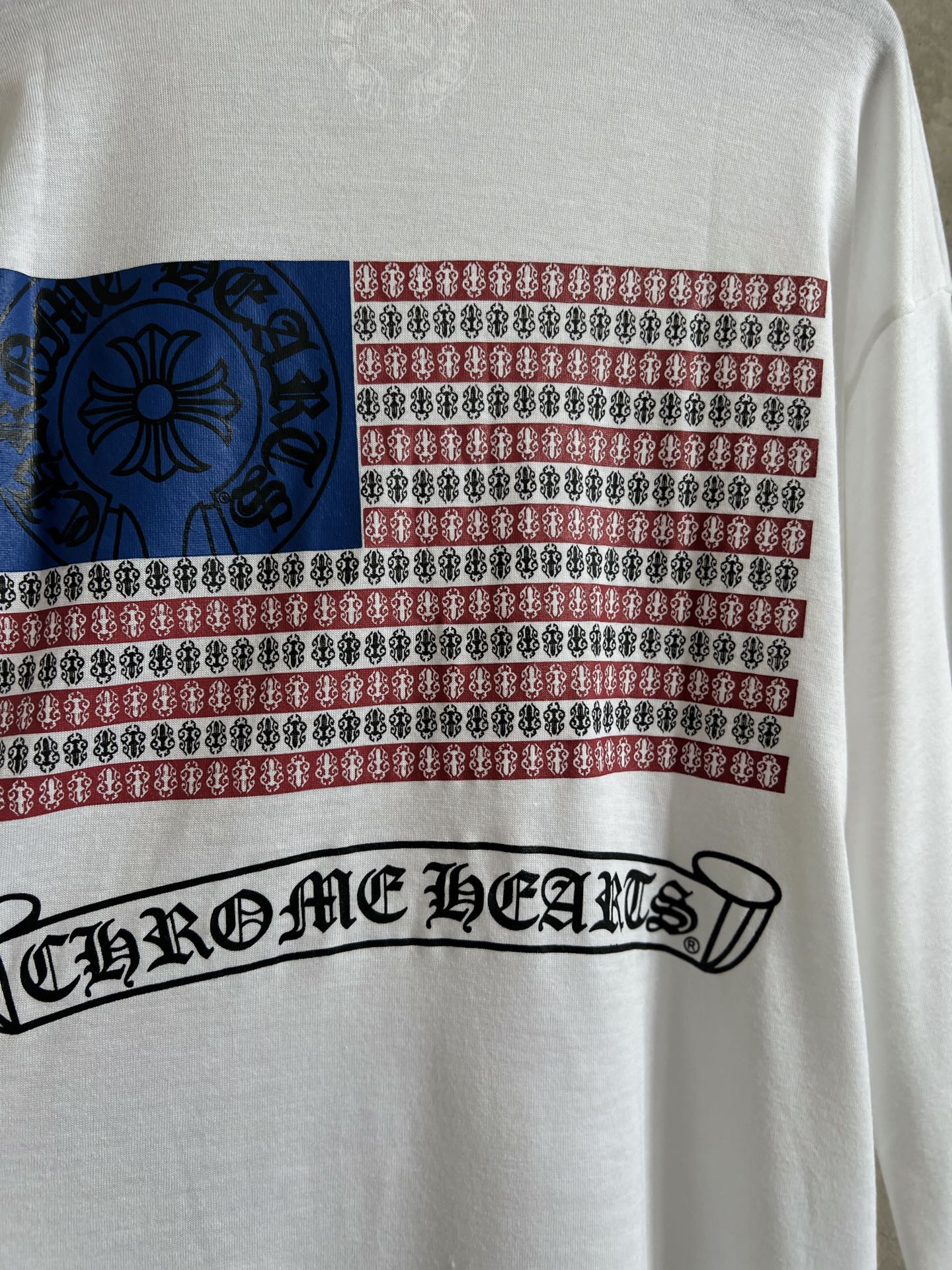 Close-up front print with striped band and script-style logo across the lower chest.