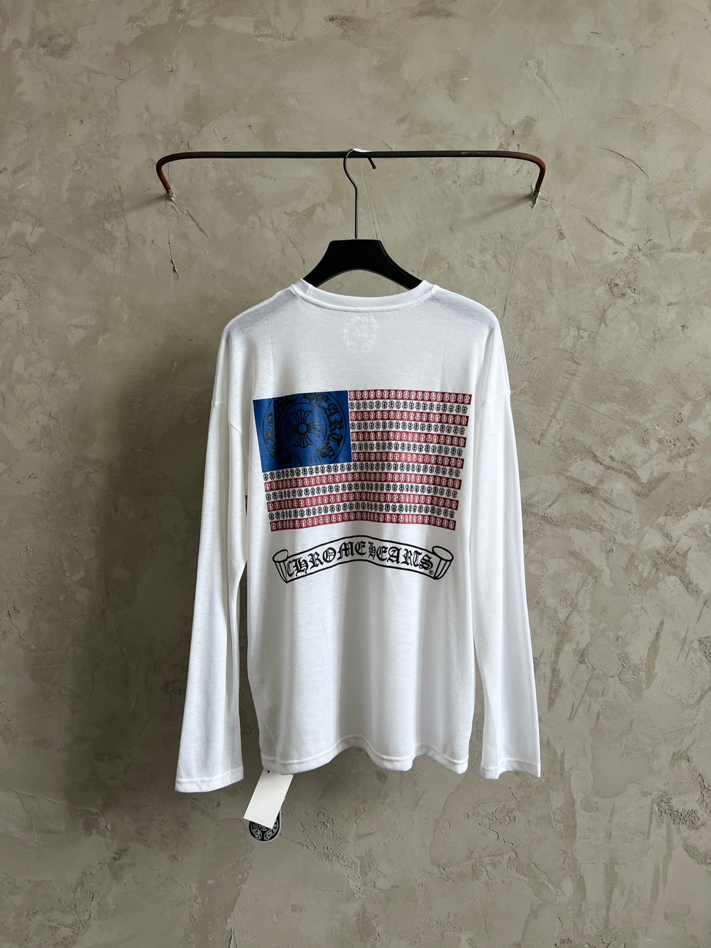 White long-sleeve shirt with front graphic featuring striped pattern and band logo.