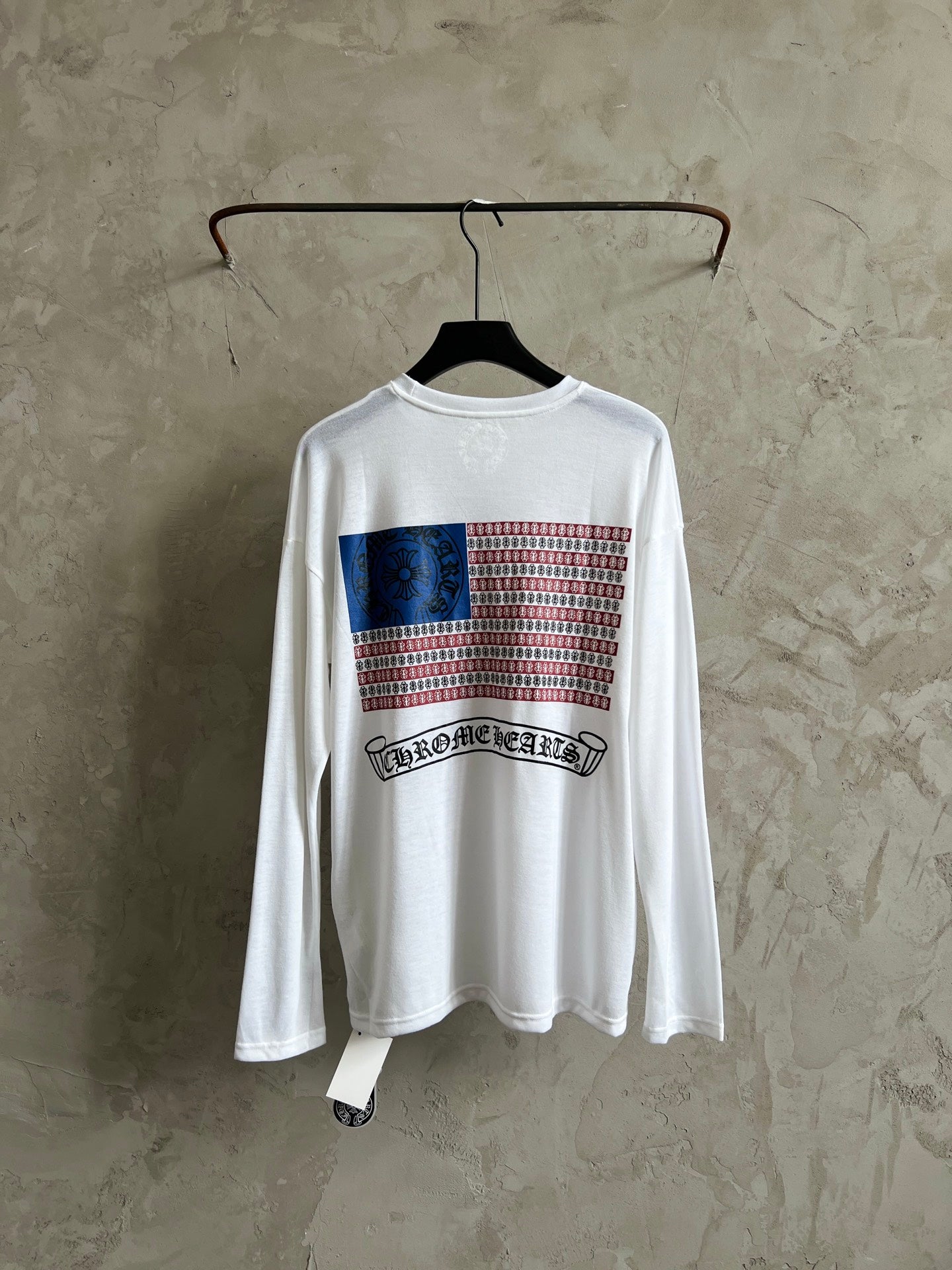 White long-sleeve shirt with front graphic featuring striped pattern and band logo.