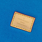 Louis Vuitton label patch on blue felt interior, with stitched border