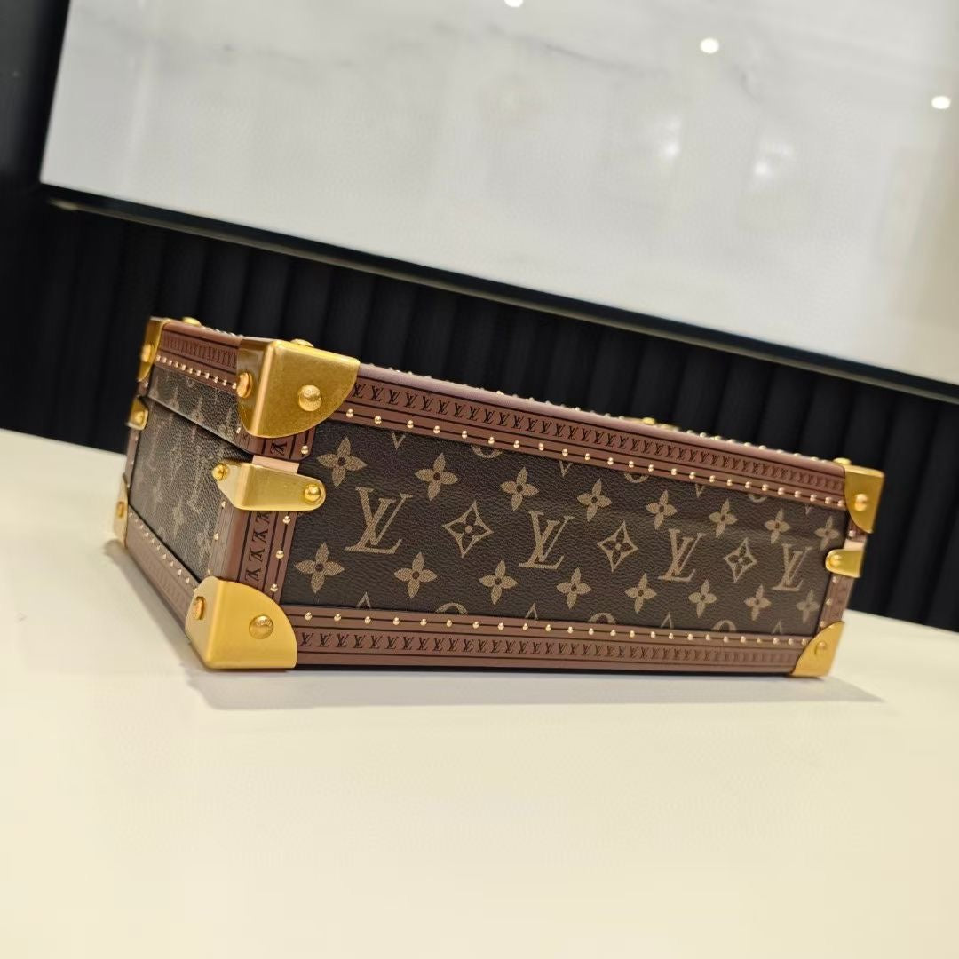 Louis Vuitton monogram trunk bag, side view, with gold latch and corner straps