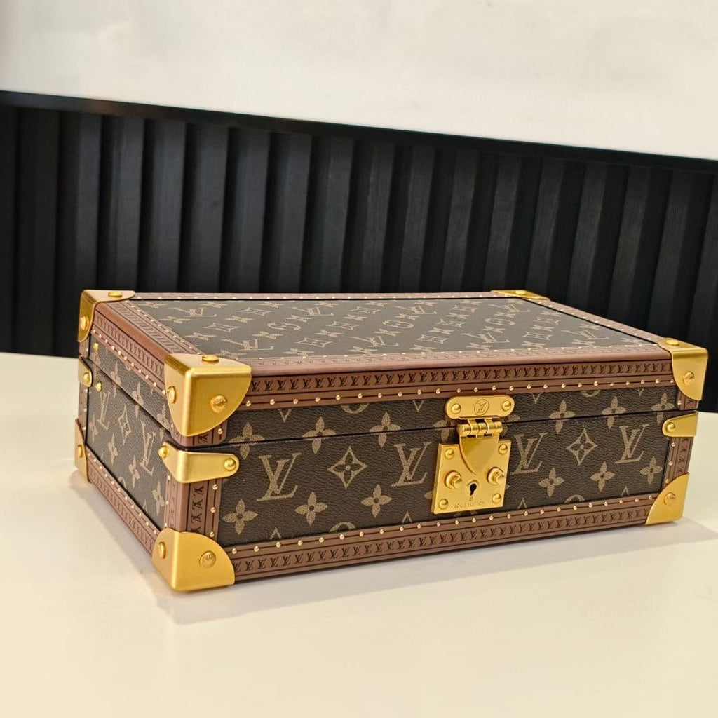 Louis Vuitton monogram trunk with gold corner accents, top view