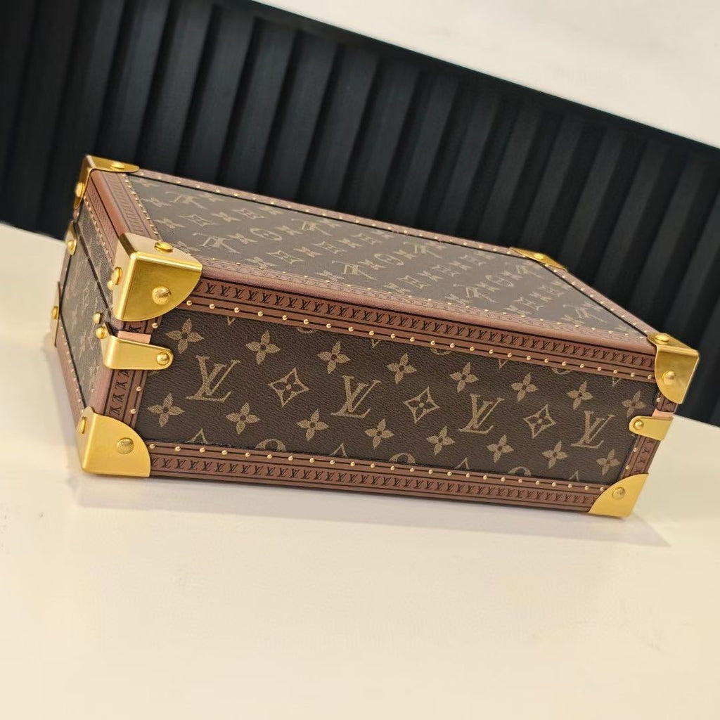 Louis Vuitton monogram trunk with gold hardware, angled view