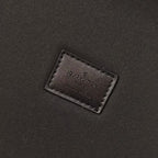 Louis Vuitton monogram trunk leather brand patch on dark fabric