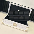 Louis Vuitton monogram jewelry box open with black padded compartments and clasp center