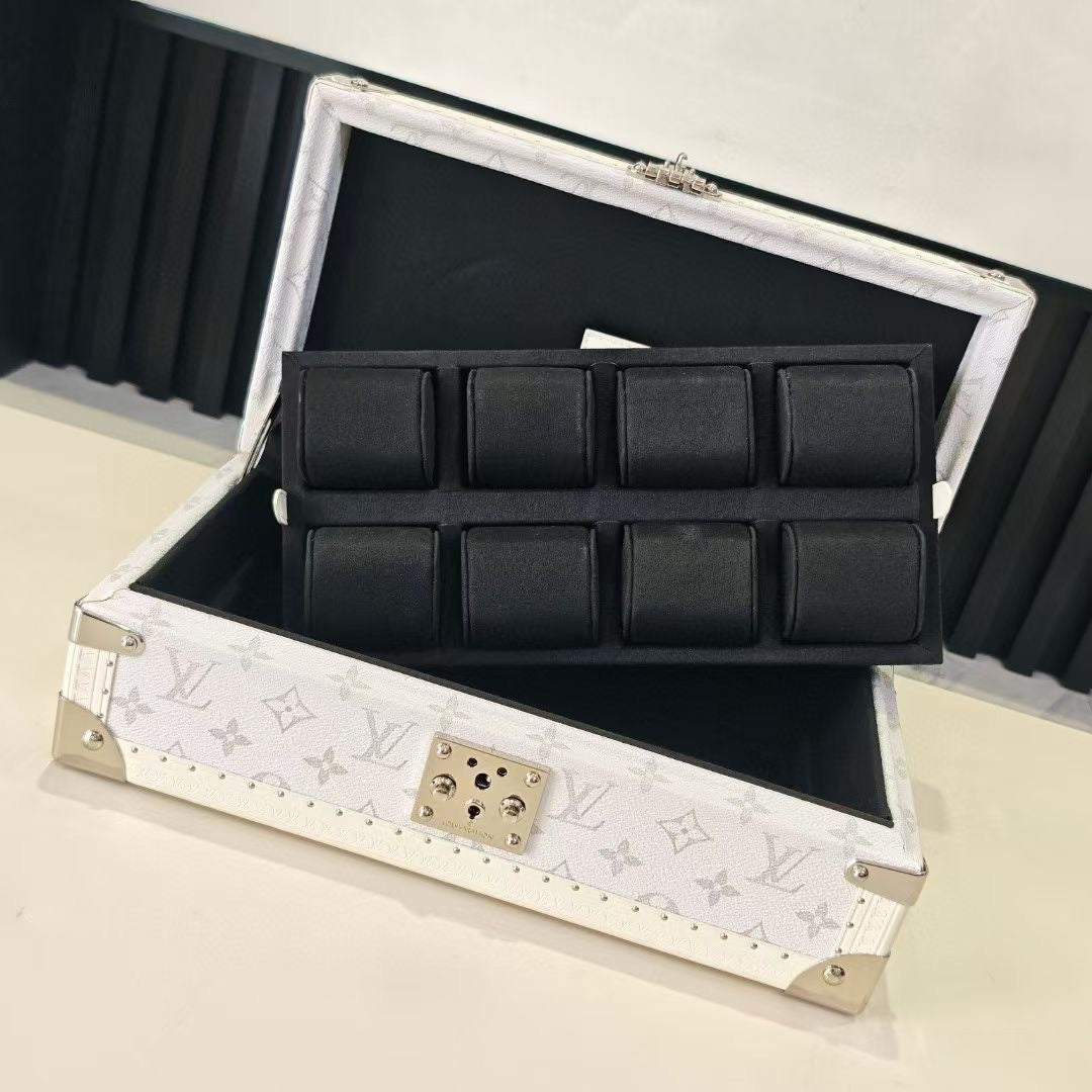 Louis Vuitton monogram jewelry box open with black padded compartments and clasp center