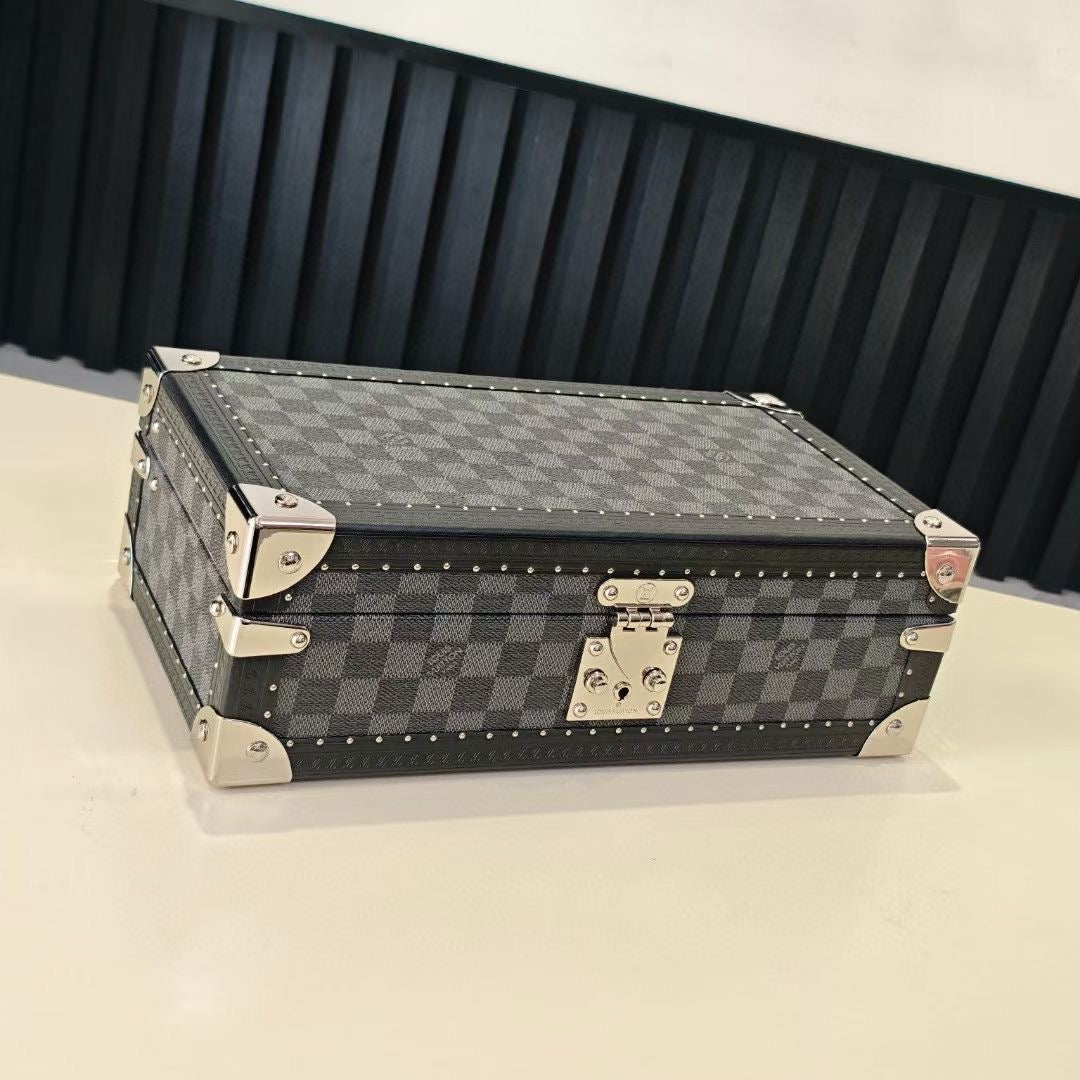 Checkered storage case with metal corner hardware and hinged clasp, side view