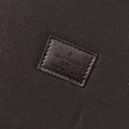 Louis Vuitton branded leather patch on black fabric interior panel