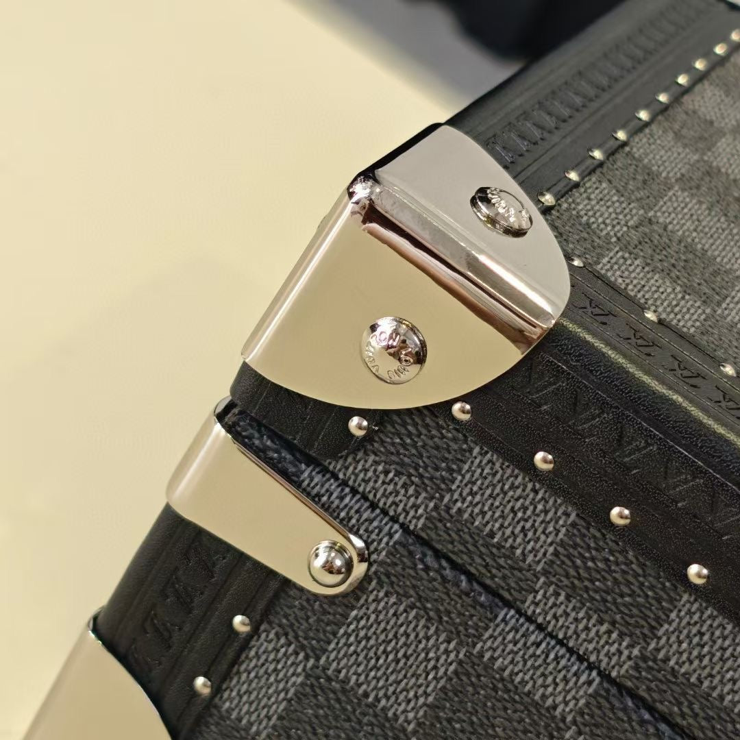 Louis Vuitton check-pattern corner hinge with silver-tone metal latch and rivets