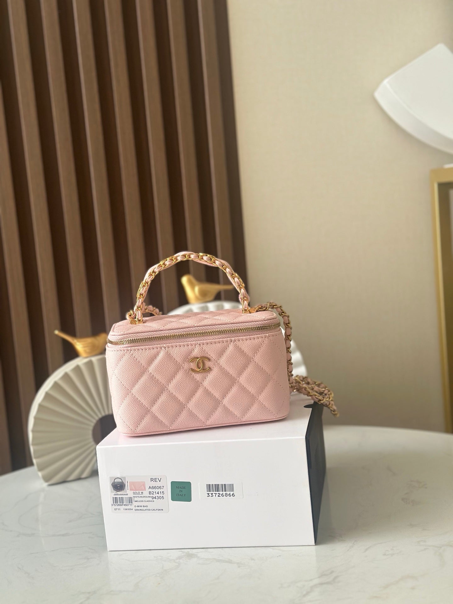 Chanel mini quilted bag in light pink with top handle and gold-tone chain strap