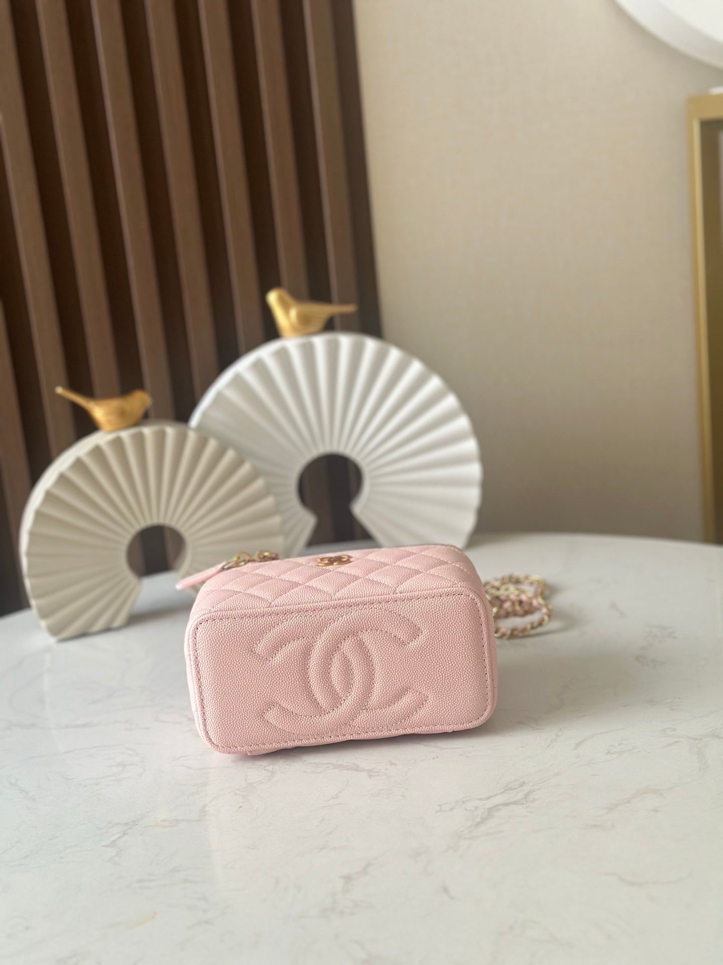 Chanel mini bag in light pink with embossed quilting and gold chain strap