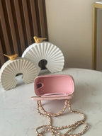 Chanel mini bag back view in light pink with gold chain strap and zip closure