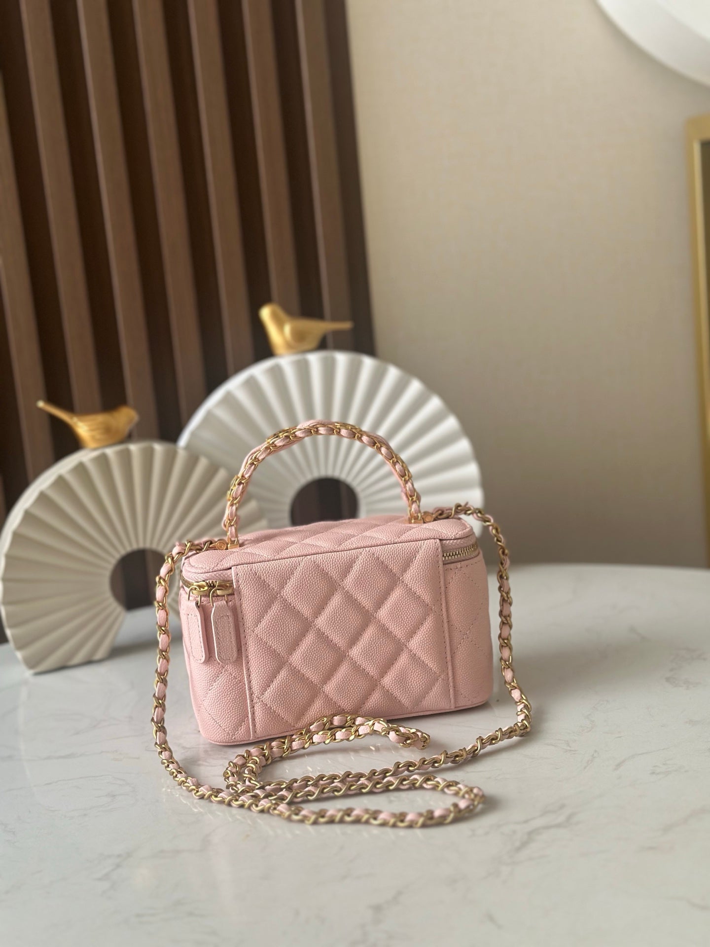 Chanel mini quilted bag in light pink with top handle and gold-tone chain strap