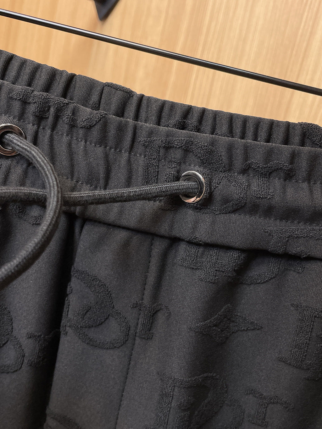 Close-up of black drawstring and elastic waistband on Dior monogram joggers