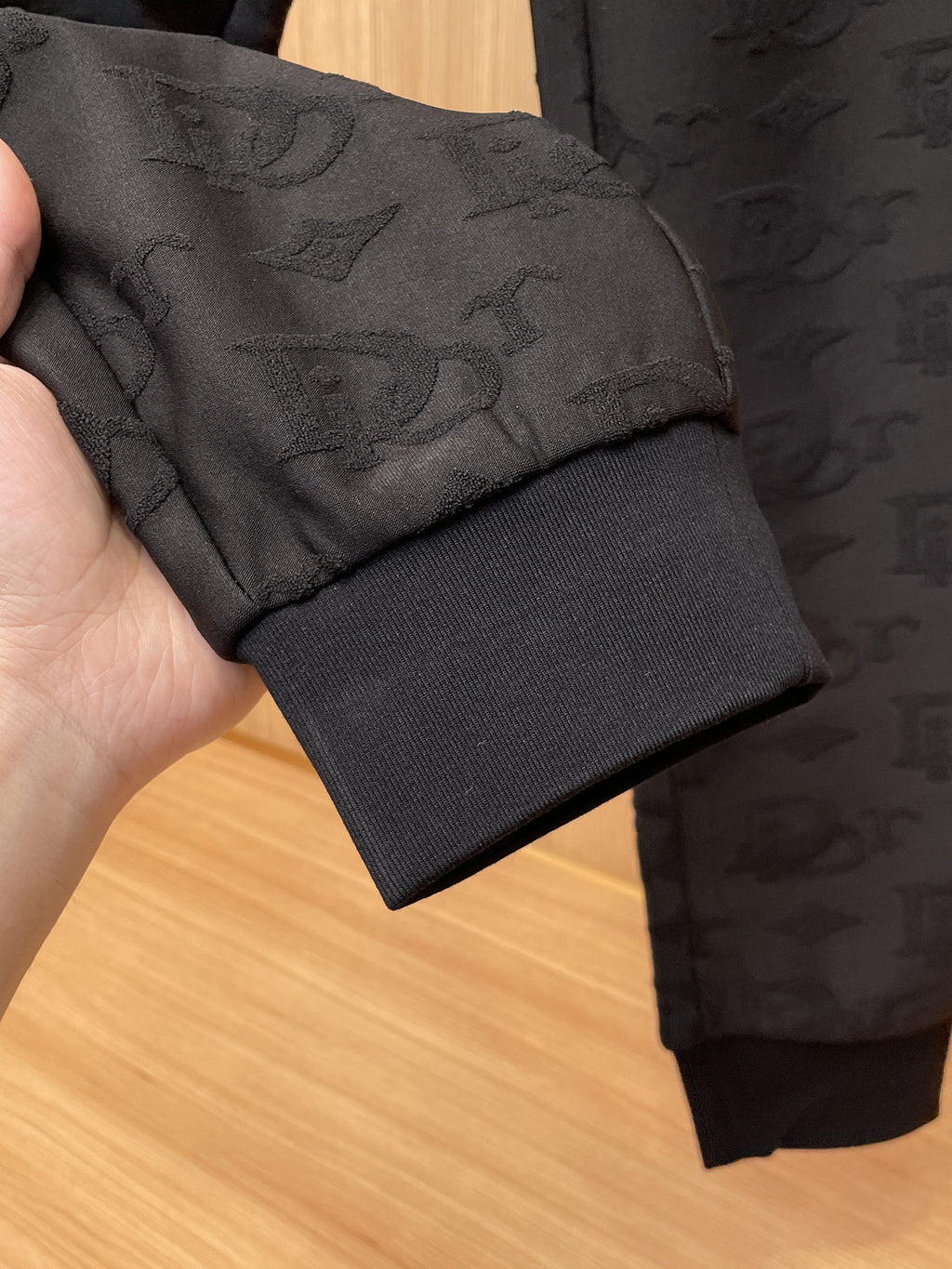 Close-up of black pant cuff and interior seam on Dior monogram jogger pants