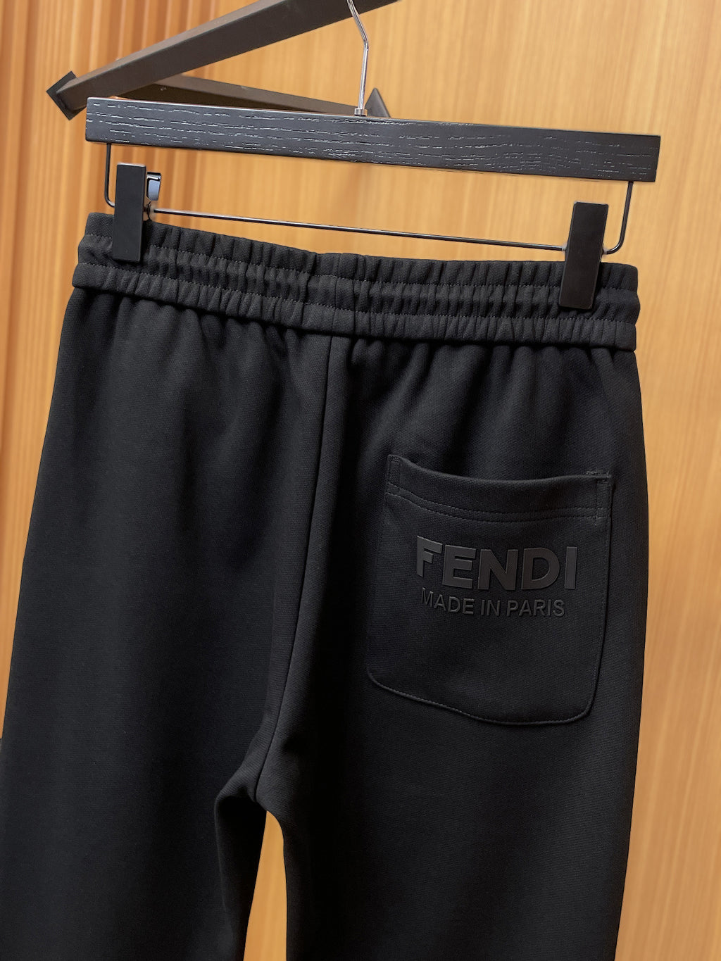 Fendi pants with elastic waistband and dark side pocket featuring “FENDI” text