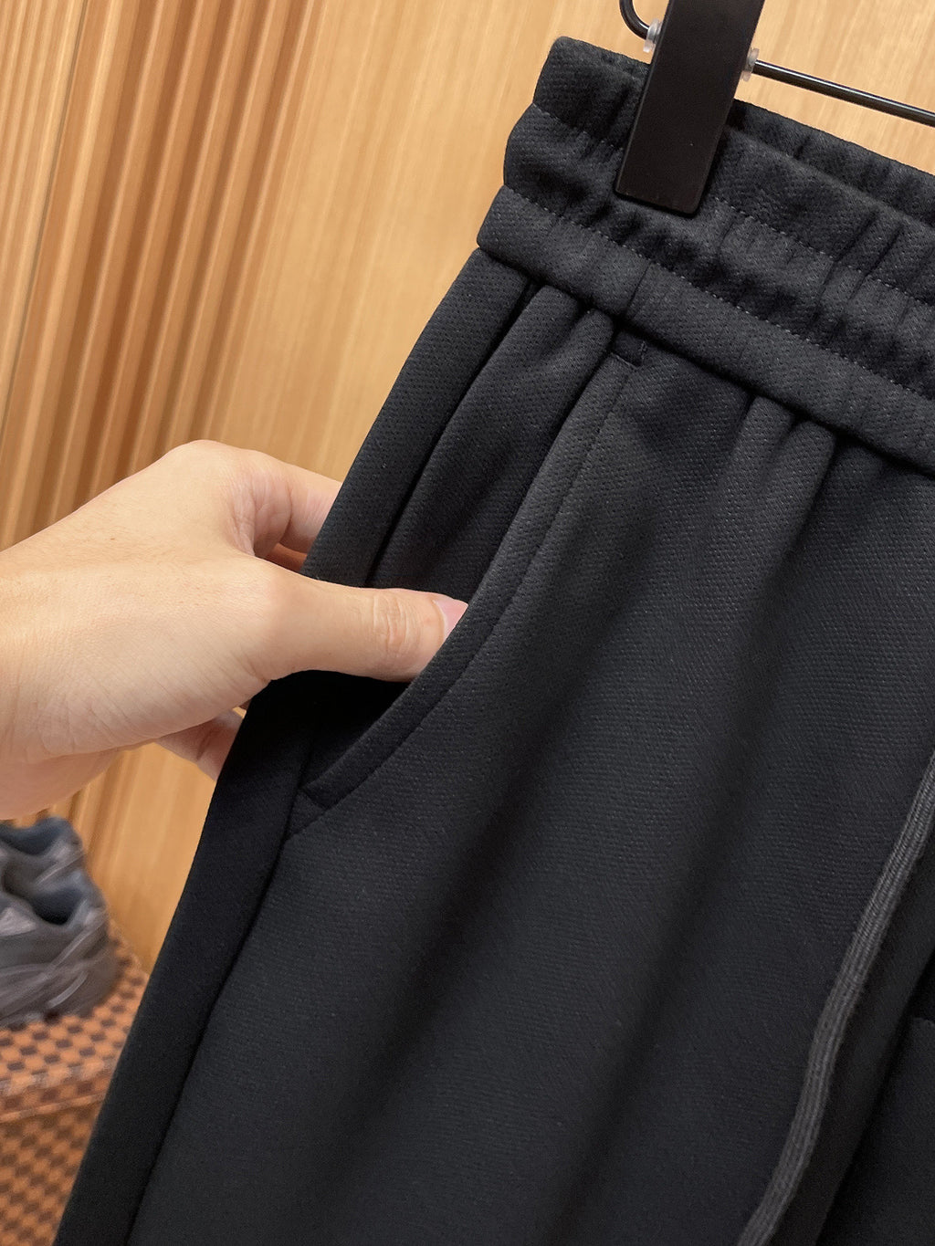 Fendi pants fabric gathered waistband with hand holding dark drawstring area