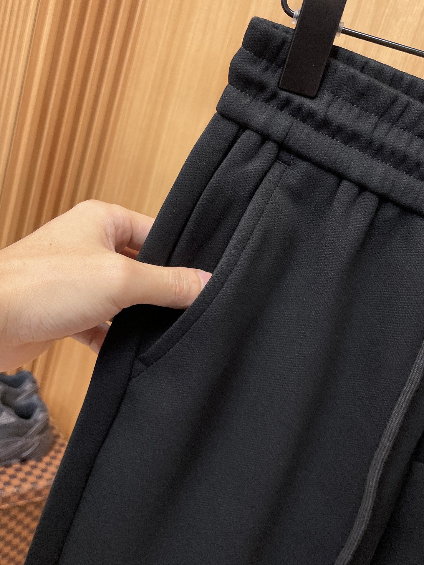 Fendi pants fabric gathered waistband with hand holding dark drawstring area