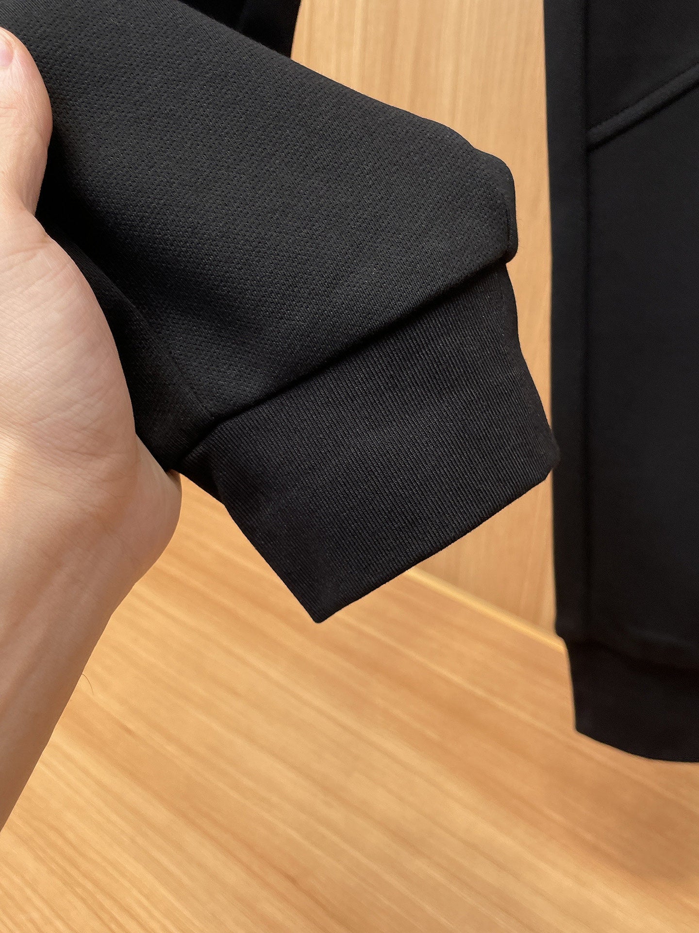 Fendi pants cuff detail on dark fabric, folded hem edge