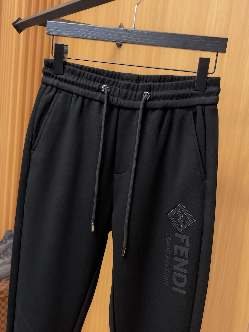 Fendi pants with elastic waistband, dark drawcord, and side logo patch