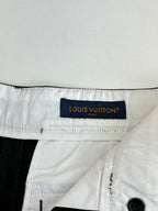 White fabric waistband label on dark pants with belt loops
