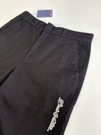 Dark straight-leg pants with embroidered side logo and front crease