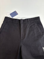 Dark pants with pleated waistband and back center seam detail
