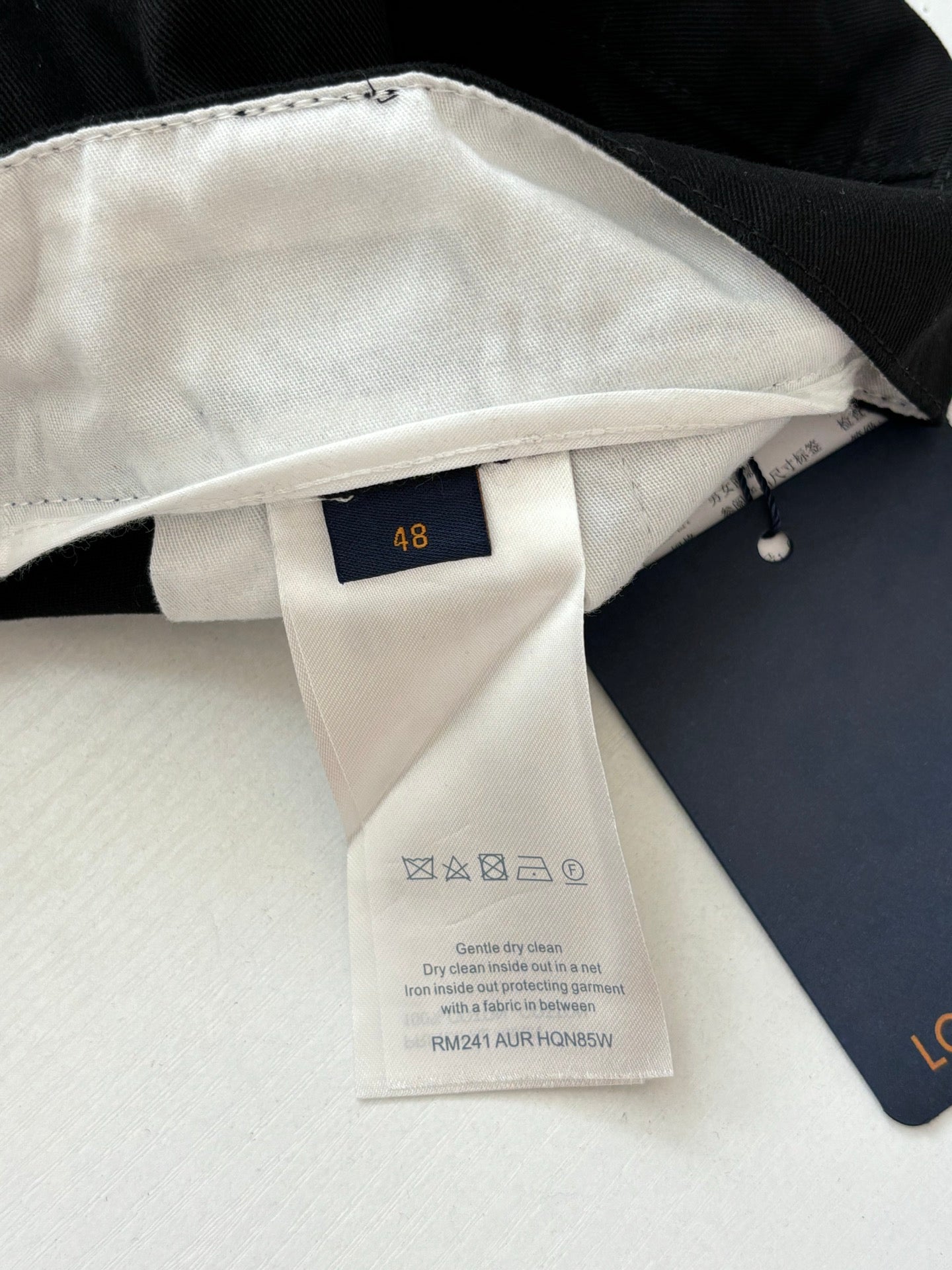 Louis Vuitton pants care label with size 48 tag, inner waistband detail