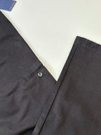 Dark tailored pants with button closure and belt loops at waistband