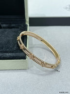 Gold-and-silver tone bracelet with charm rows and textured beaded border