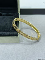 Gold-tone bracelet with beaded border and delicate central charm row