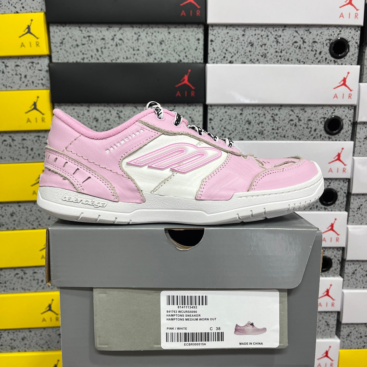 Pink and white low-top Balenciaga unisex sneakers, side view, lace-up.