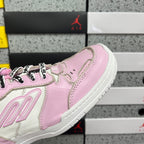 Pink and white low-top sneaker, side panel and lace-up detail, close view.