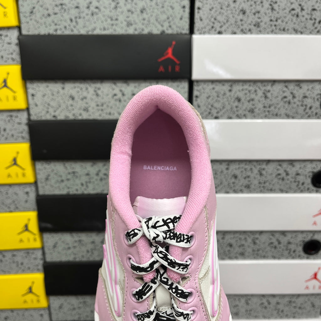 Pink low-top sneaker tongue and collar lining with lace-up front close-up.