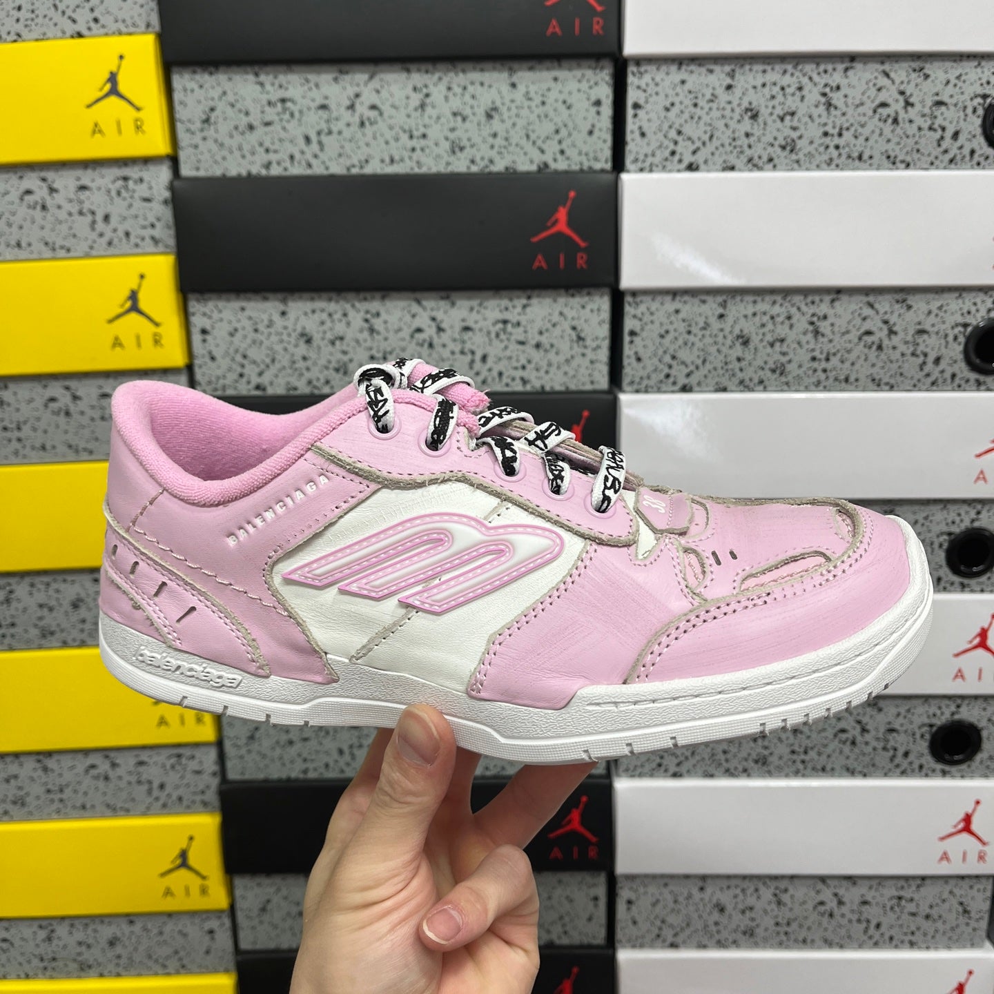 Pink and white low-top Balenciaga unisex sneakers with lace-up front.