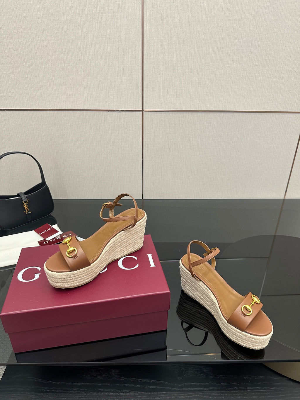 Tan espadrille wedge sandals with gold buckle strap and slingback design