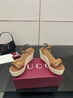 Tan leather espadrille platform wedge sandals with gold buckle on upper