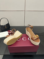 Tan wedge sandals with braided espadrille sole and gold buckle accent