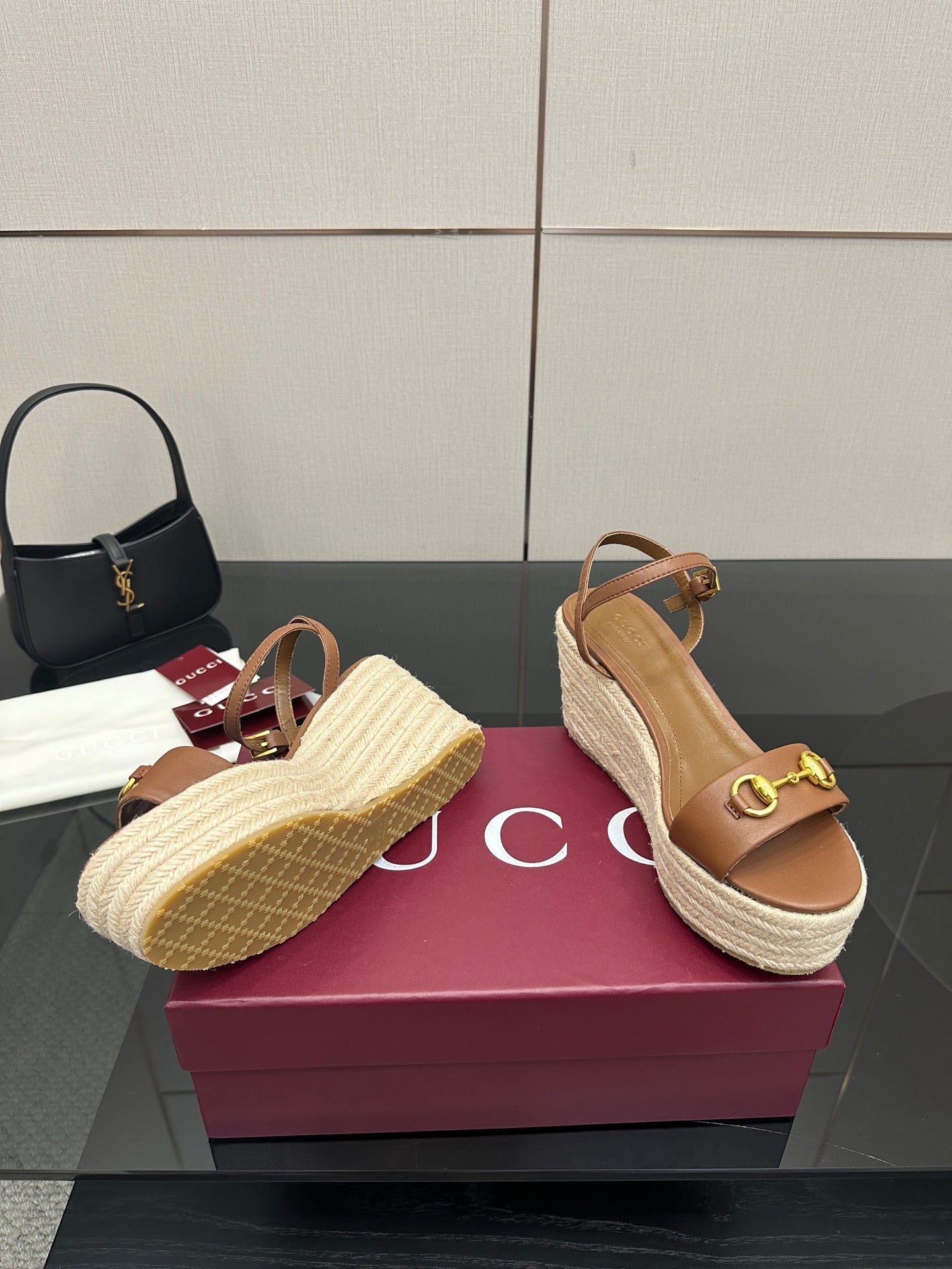 Tan wedge sandals with braided espadrille sole and gold buckle accent