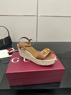 Tan leather slingback wedge sandals with gold-tone buckle and espadrille sole