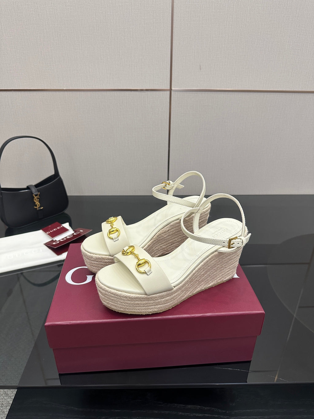 Gucci white platform wedge sandals with crisscross ankle straps and gold hardware.