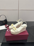 Gucci white platform wedge sandals with crisscross ankle straps and gold hardware.