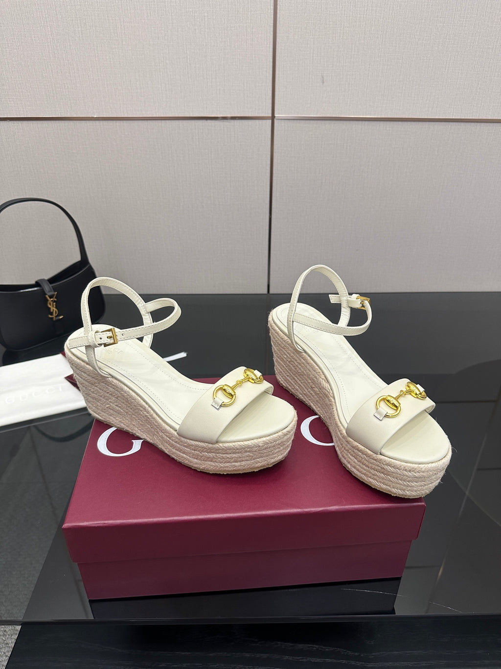 Gucci white wedge sandals with gold bit buckle ornament and espadrille-style sole.