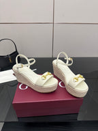 Gucci white wedge sandals with gold bit buckle ornament and espadrille-style sole.