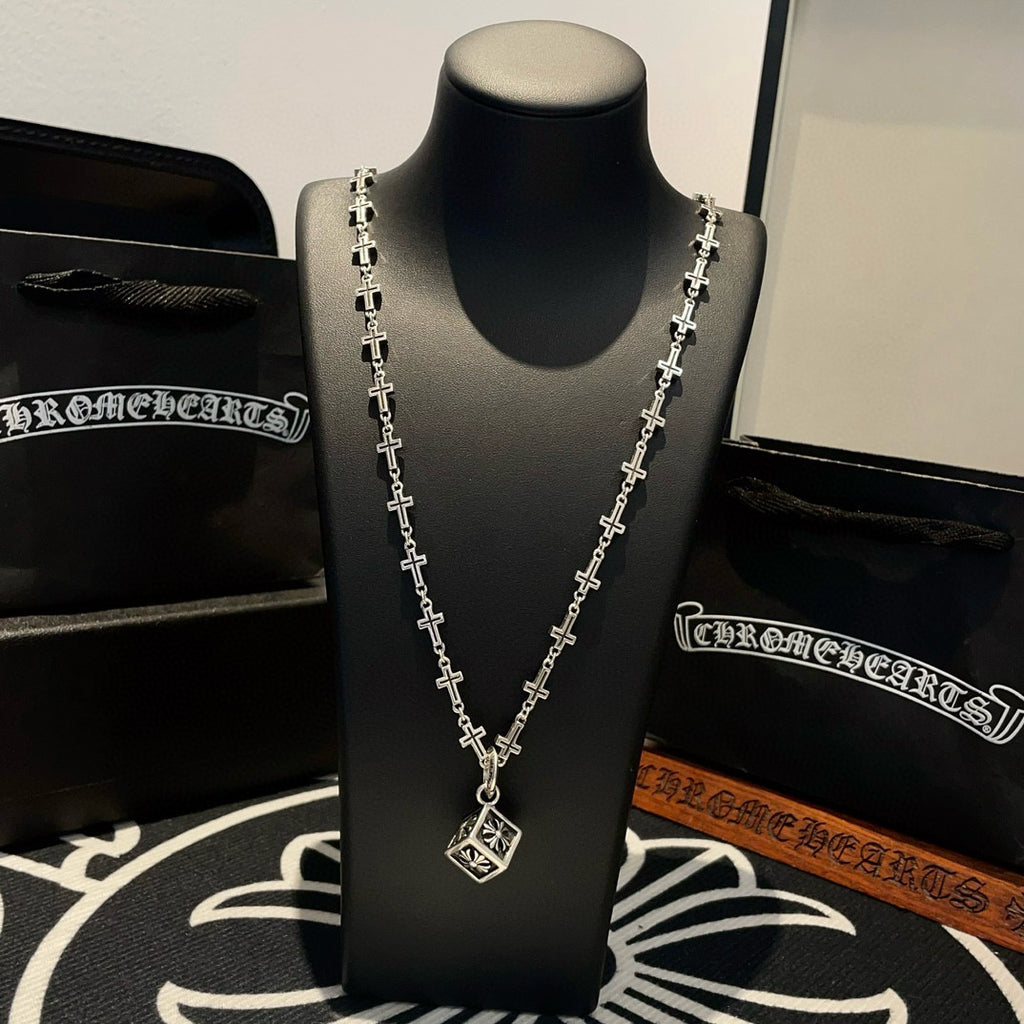 Silver-tone cross-link chain necklace on bust with square pendant at center