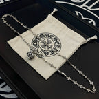 Silver-tone cross-link chain necklace with square pendant on drawstring pouch