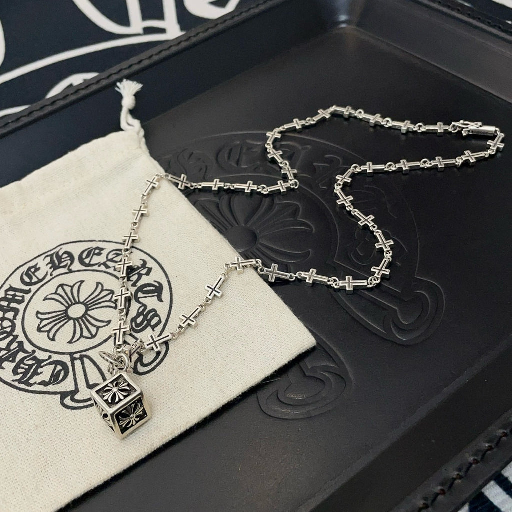 Silver-tone cross-link chain necklace with square pendant on box and pouch