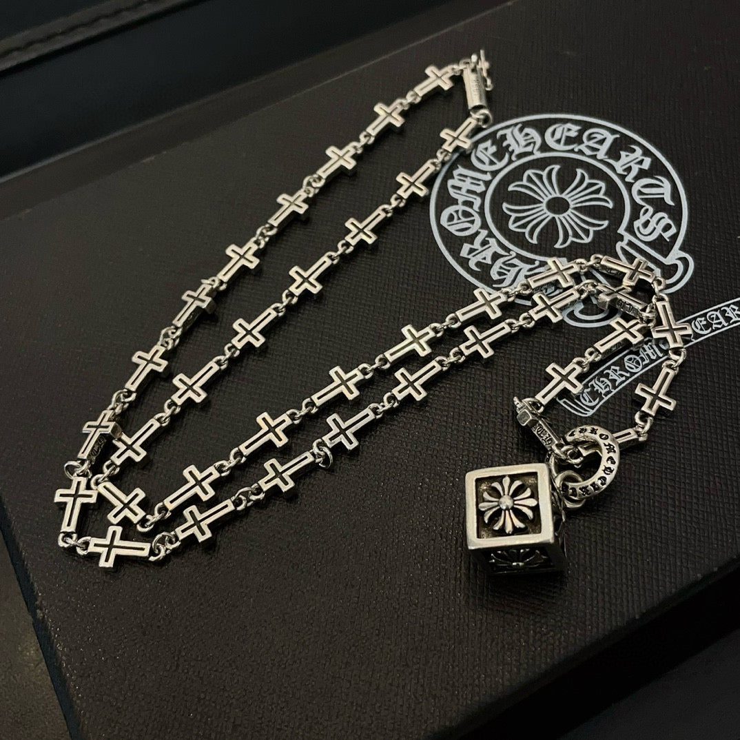 Silver-tone cross-link chain necklace with square pendant, ring charm, and clasp