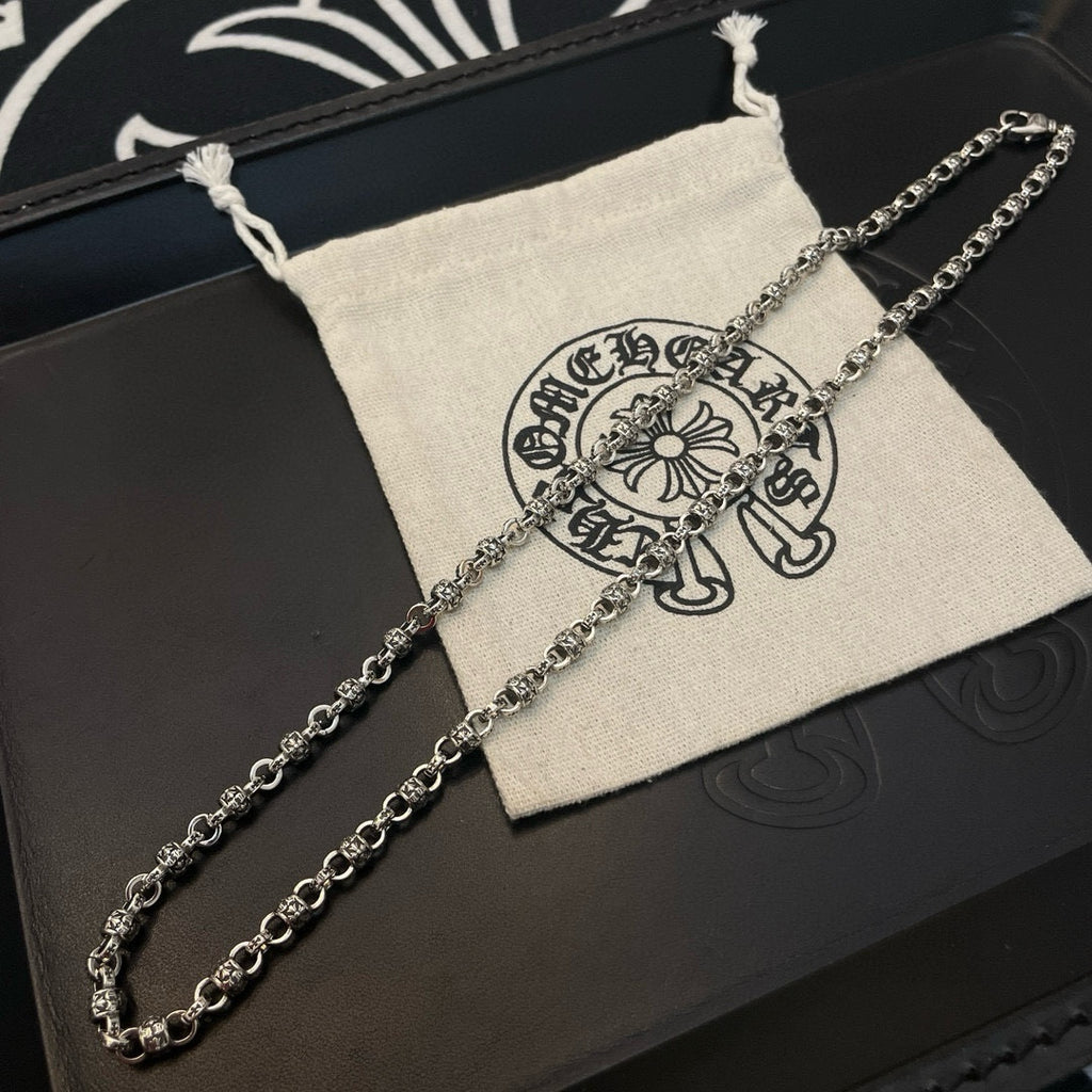 Metal chain necklace with logo pouch on black box