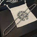Metal chain necklace with logo pouch on black box